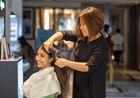 Hair extension in Ives Estates applied by professional stylist at Hair By Fleur, blending natural color, texture, and length for seamless results